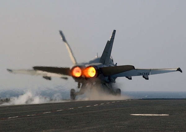  A U.S. Navy F/A-18 Hornet being launched from the catapult on full afterburner. 
